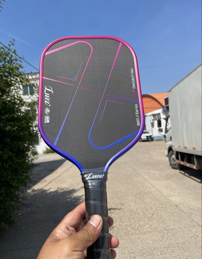 Luzz Pickleball Paddle Pro-4 Inferno FR-Poly Core (Category: Racket and Ball Sports) located in Manila. Submitted by levelup0 (Listing ID 1448488106, Image 3). Description: - Luno Pro-4 Inferno Pickleball Paddle - Eye-catching Pink and Blue Gradient Design - FR-Poly Core for enhanced play - Includes original packaging - Ideal for pickleball enthusiasts.