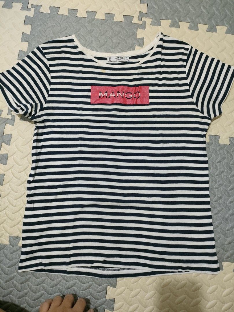 Mango Striped T-shirt with Pink Logo (Category: Shirts) located in General Santos City (Dadiangas). Submitted by rjb21 (Listing ID 1448547207, Image 1). Description: - Classic black and white stripes - Bold pink 'MANGO' logo on chest - Short sleeves - Comfortable, relaxed fit - Versatile for casual wear - Pairs well with jeans or shorts issue- with light stain.