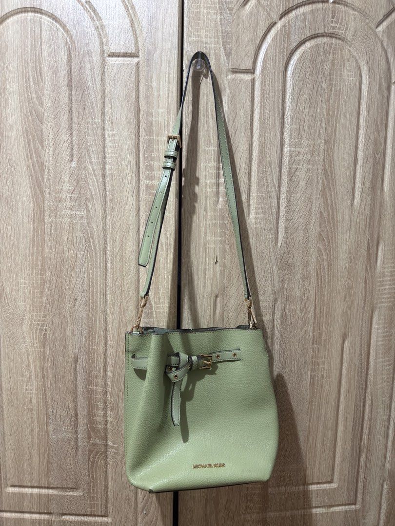 Michael Kors Green Leather Bucket Bag (Category: Luxury Bags & Wallets) located in San Mateo. Submitted by eunoiaclothingph2.0 (Listing ID 1448605865, Image 1). Description: MK Emilia Drawstring Bucket Bag in Light Sage - Authentic Michael Kors green leather bucket bag - Features an adjustable strap with elegant gold hardware - Secure tie closure with a stylish buckle detail - Iconic Michael Kors logo prominently displayed on the front - Ideal fo