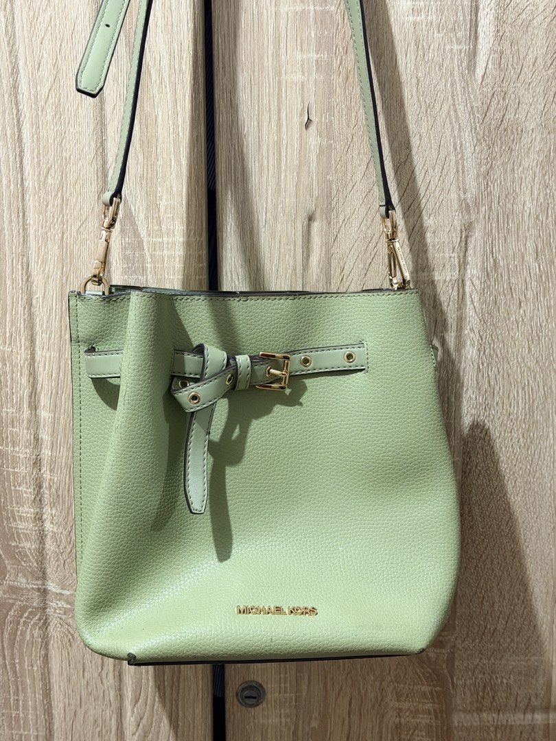 Michael Kors Green Leather Bucket Bag (Category: Luxury Bags & Wallets) located in San Mateo. Submitted by eunoiaclothingph2.0 (Listing ID 1448605865, Image 2). Description: MK Emilia Drawstring Bucket Bag in Light Sage - Authentic Michael Kors green leather bucket bag - Features an adjustable strap with elegant gold hardware - Secure tie closure with a stylish buckle detail - Iconic Michael Kors logo prominently displayed on the front - Ideal fo