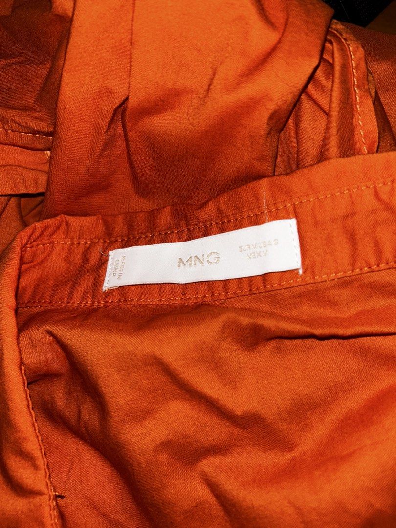 MNG Orange Button-Up Shirt Dress (Category: Dresses) located in Cebu City. Submitted by _____08_____ (Listing ID 1448622002, Image 2). Description: - EUR M USA S - Orange MNG dress - Short sleeves - Collared neckline - Button-up front - Comes with a tie belt to cinch the waist - Crinkled fabric texture - Perfect for casual outings or dressing up.