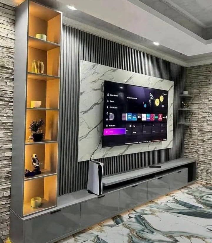 Modern Grey TV Console with Wall Unit and Shelving (Category: TV Consoles) located in Iloilo. Submitted by semicglinda (Listing ID 1448607457, Image 1). Description: - Sleek grey TV console with ample storage drawers. - Modern wall unit design with elegant marble accent. - Integrated shelving with built-in lighting for display. - Perfect for a contemporary living room setup. - Includes a vertical console specifically designed for a PlayStation 5.