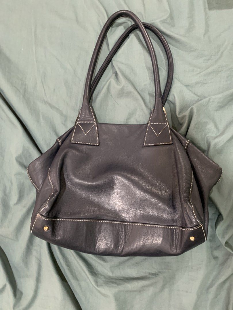 Nannini Italy Leather Shoulder Bag (Category: Shoulder Bags) located in Binan City. Submitted by bentenison (Listing ID 1448575088, Image 2). Description: - Dark navy leather shoulder bag by Nannini - Made in Italy - Soft leather with elegant white contrast stitching - Secure top zip closure - Interior features a zip pocket and slip pockets - Includes original leather tag - Ideal for everyday carry.