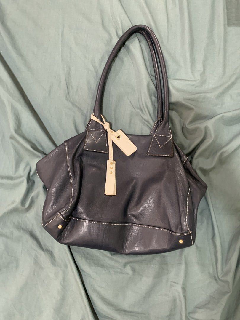 Nannini Italy Leather Shoulder Bag (Category: Shoulder Bags) located in Binan City. Submitted by bentenison (Listing ID 1448575088, Image 1). Description: - Dark navy leather shoulder bag by Nannini - Made in Italy - Soft leather with elegant white contrast stitching - Secure top zip closure - Interior features a zip pocket and slip pockets - Includes original leather tag - Ideal for everyday carry.