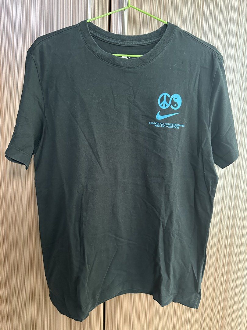 Nike T-Shirt (Category: Shirts) located in Taguig. Submitted by stigmapanda (Listing ID 1448693742, Image 1). Description: - Black Nike T-Shirt - Measurements are in cm - Unique graphic on back: Peace sign + Yin-Yang + Nike Swoosh combo - Copyright 2009 - Ideal for casual wear - Comfortable and stylish.