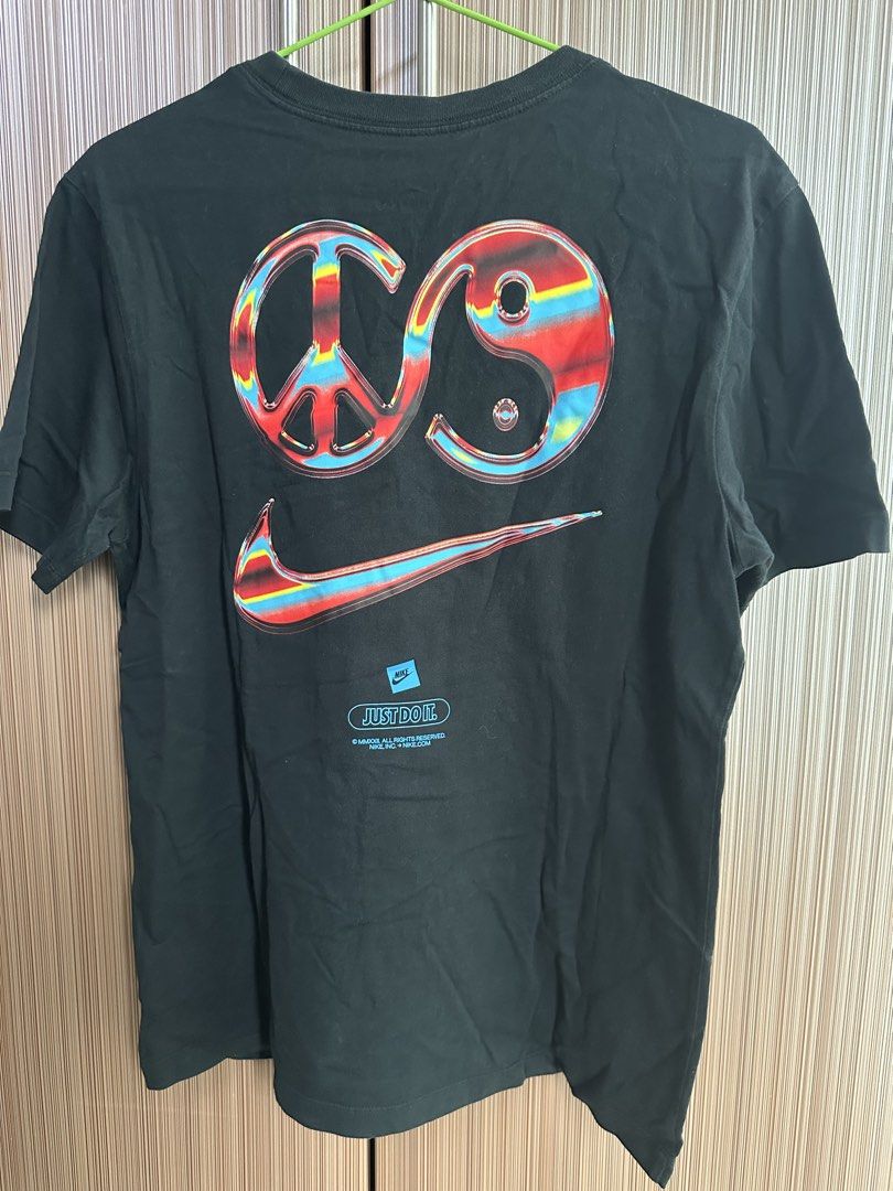 Nike T-Shirt (Category: Shirts) located in Taguig. Submitted by stigmapanda (Listing ID 1448693742, Image 3). Description: - Black Nike T-Shirt - Measurements are in cm - Unique graphic on back: Peace sign + Yin-Yang + Nike Swoosh combo - Copyright 2009 - Ideal for casual wear - Comfortable and stylish.