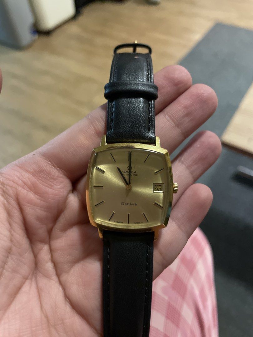Omega Genève Automatic Gold Tone Watch (Category: Luxury Watches) located in Agdangan. Submitted by kikayfindsph (Listing ID 1448660419, Image 1). Description: - Vintage Omega Genève watch - Automatic movement with date function - Gold tone case and dial - Black leather strap - Runs well.