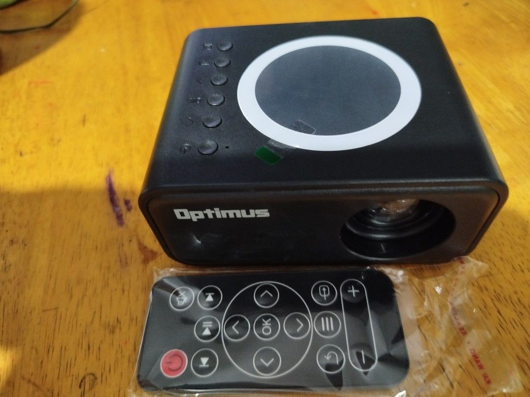 Optimus Mini Projector with Remote (Category: Projectors) located in Calamba. Submitted by aguilardominique (Listing ID 1448607655, Image 1). Description: - Optimus Mini Projector - Includes remote control - Ideal for movie nights and presentations - Compact and user-friendly design - Tested and works well.
