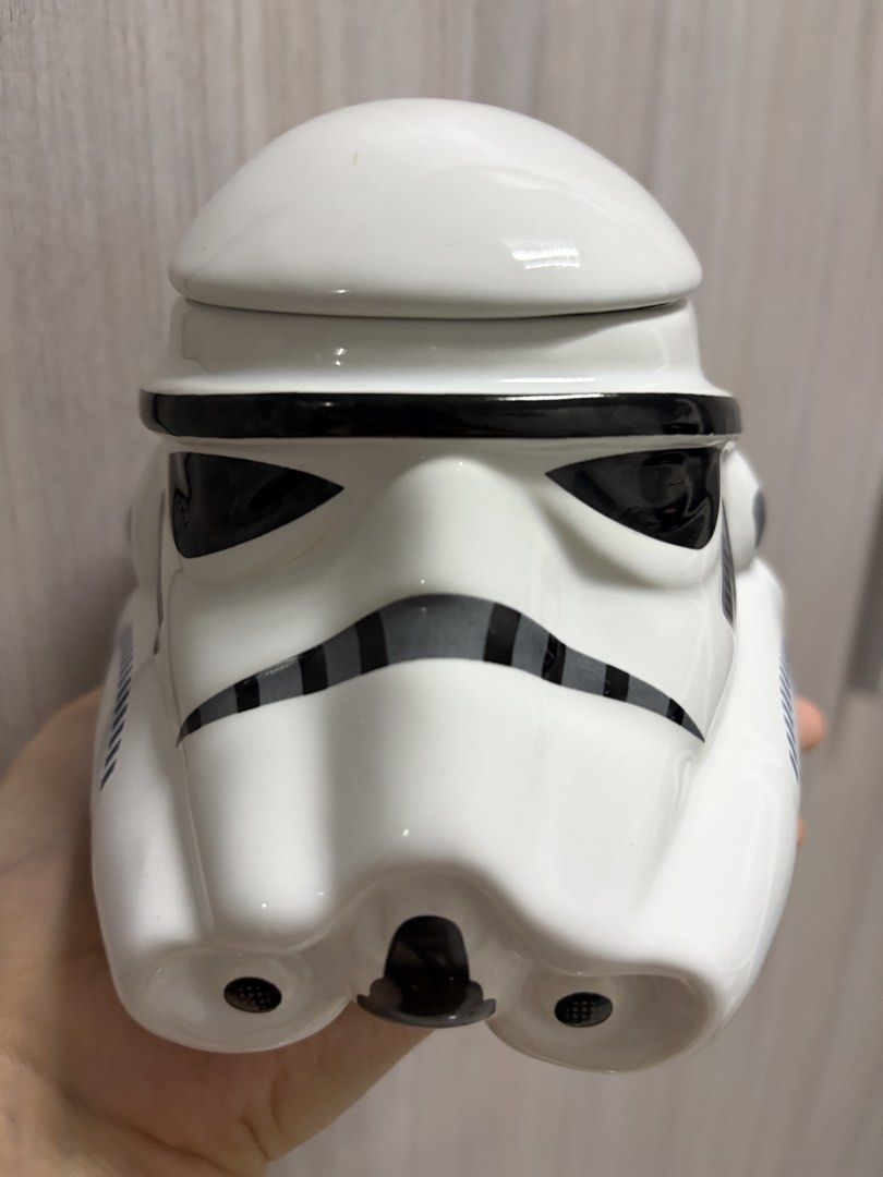 Painted Star Wars Stormtrooper Helmet Mug with Lid (Category: Coffee & Tea Tableware) located in Taguig. Submitted by labellearmoire2 (Listing ID 1448691300, Image 2). Description: - Unique Star Wars Stormtrooper helmet mug - Includes a lid to keep drinks warm - Sturdy ceramic construction with a comfortable handle - Ideal for coffee, tea, or any hot beverage - A must-have for any Star Wars fan! Bumped the top of it accidentally while using only 