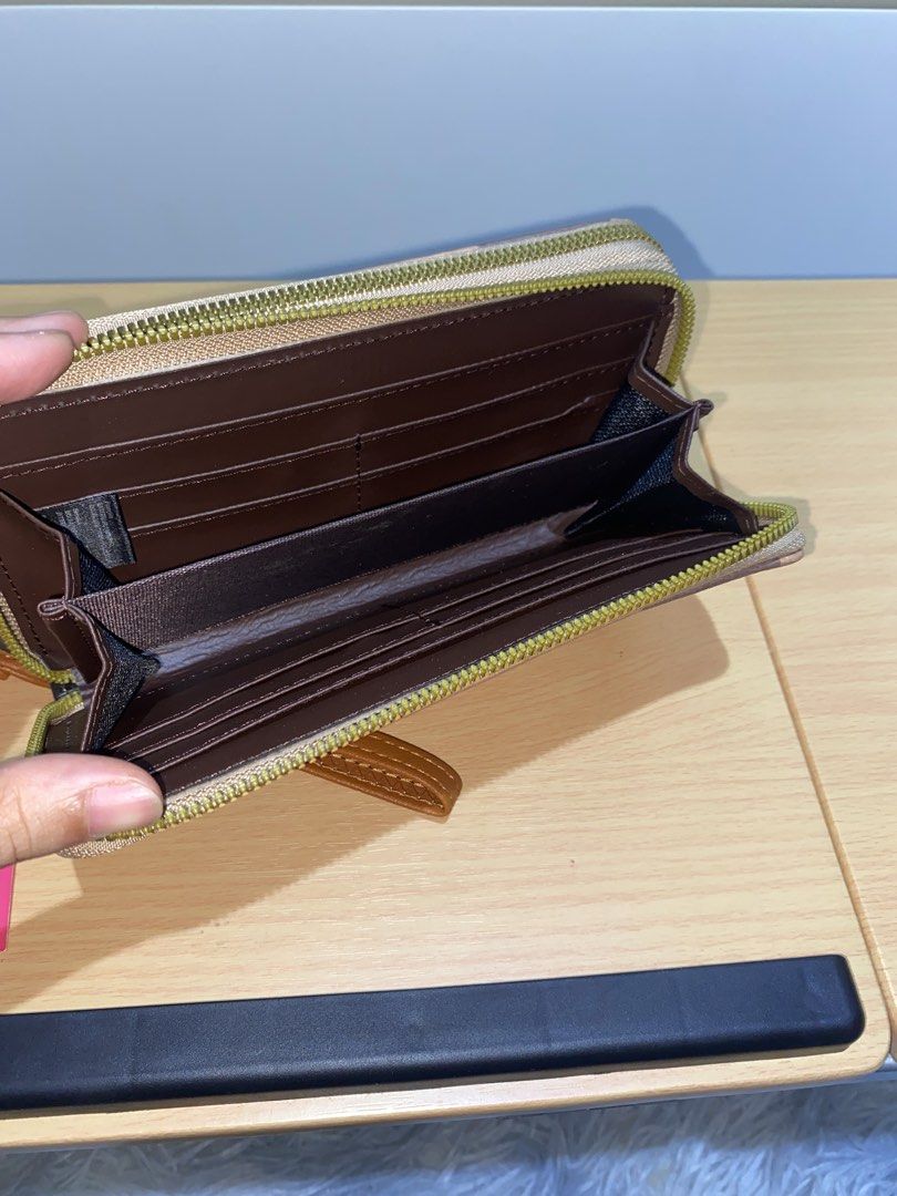 Plaid Zip Wallet with Bee Detail (Category: Wallets & Card holders) located in Dasmarinas. Submitted by ae.decluttering (Listing ID 1448609515, Image 2). Description: - Stylish checkered wallet with a cute bee emblem. - Secure zip-around closure. - 8 card slots and compartments for organization. - Convenient wrist strap included. - Ideal for keeping your essentials tidy and accessible..