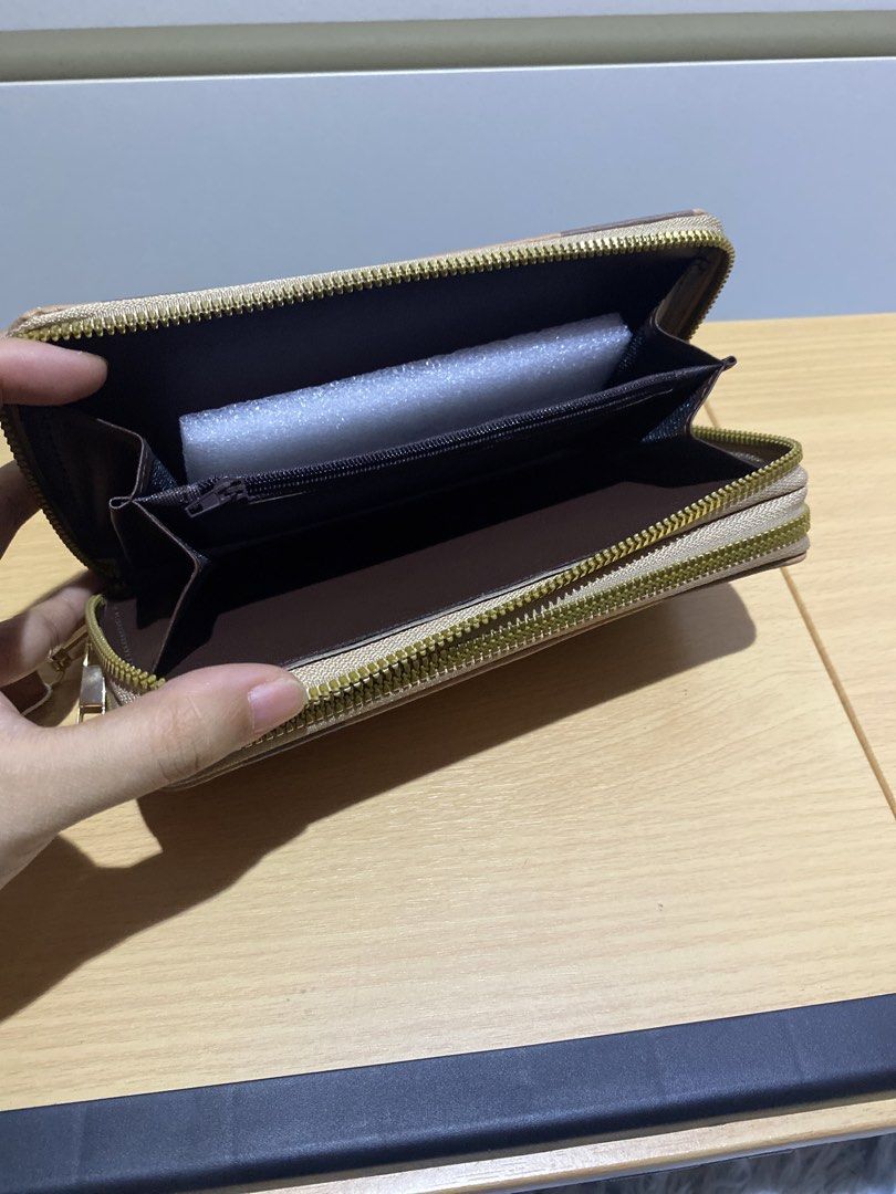 Plaid Zip Wallet with Bee Detail (Category: Wallets & Card holders) located in Dasmarinas. Submitted by ae.decluttering (Listing ID 1448609515, Image 3). Description: - Stylish checkered wallet with a cute bee emblem. - Secure zip-around closure. - 8 card slots and compartments for organization. - Convenient wrist strap included. - Ideal for keeping your essentials tidy and accessible..