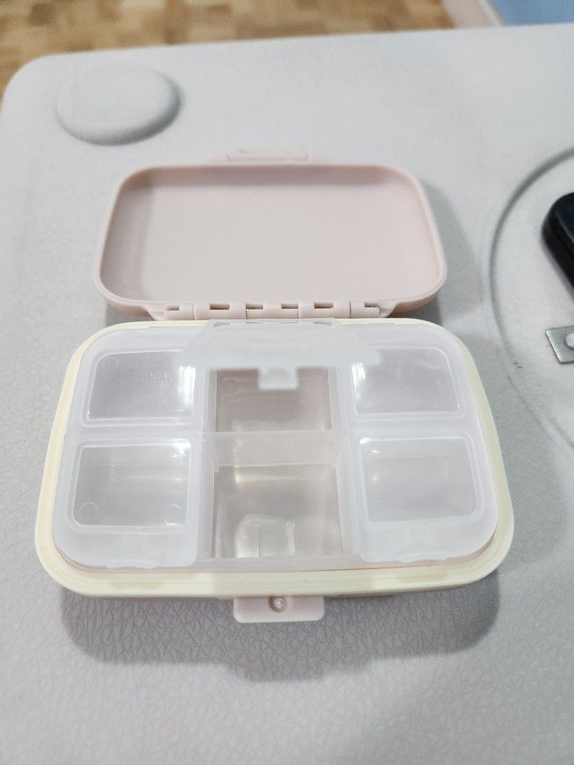 Portable and Detachable 6 Compartment Pill Organizer Case (Category: Accessory Holder, Box & Organizers) located in San Juan City. Submitted by djdlm (Listing ID 1448632764, Image 2). Description: - Brand new and never used compact and detachable pill box with 6 individual compartments - Secure snap-shut lid; 1 cover for 2 slots - Removable inner tray - Light pink/pastel color, side border slightly yellow in color - Ideal for daily vitamins, medi