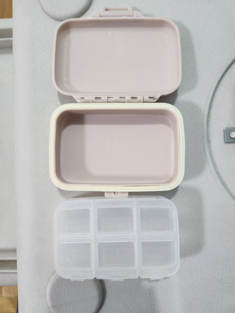 Portable and Detachable 6 Compartment Pill Organizer Case (Category: Accessory Holder, Box & Organizers) located in San Juan City. Submitted by djdlm (Listing ID 1448632764, Image 3). Description: - Brand new and never used compact and detachable pill box with 6 individual compartments - Secure snap-shut lid; 1 cover for 2 slots - Removable inner tray - Light pink/pastel color, side border slightly yellow in color - Ideal for daily vitamins, medi