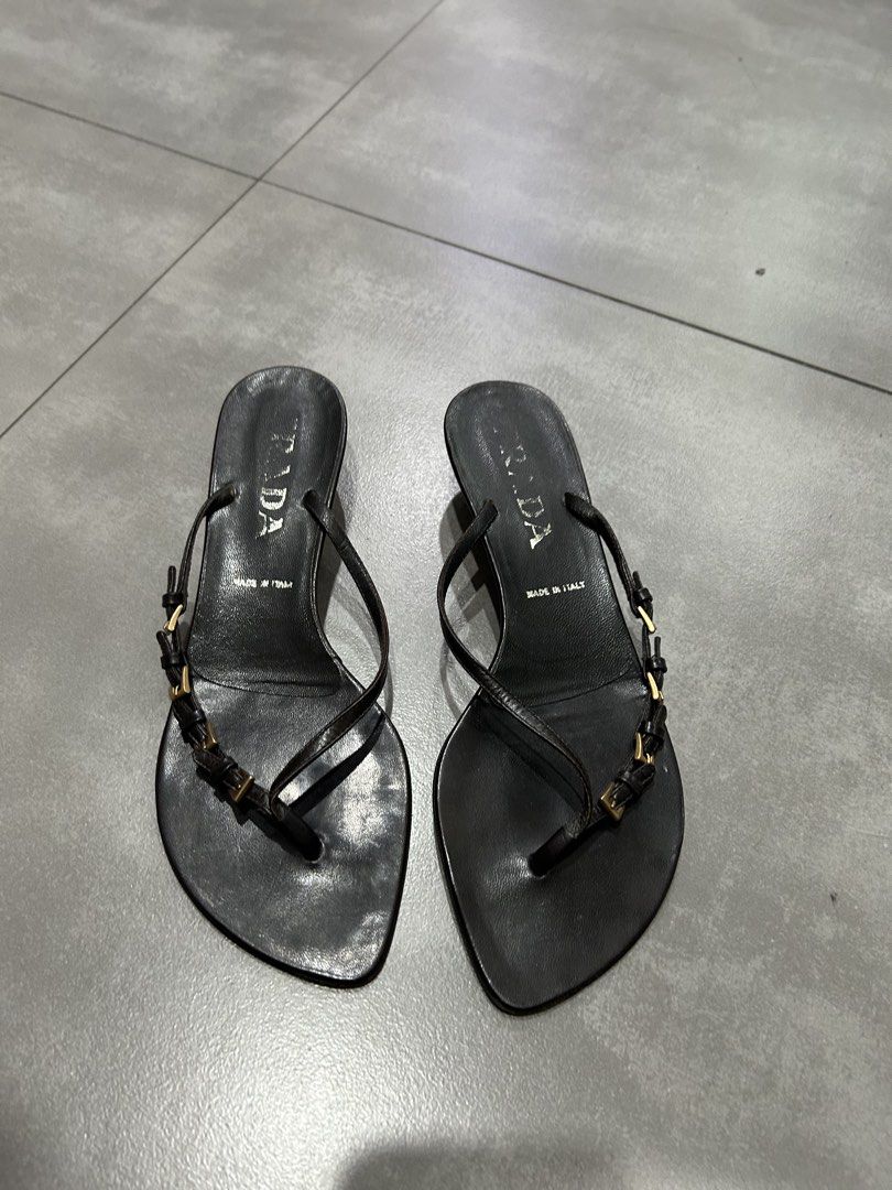 Prada Black Leather Thong Heeled Sandals Size 36 (Category: Heels) located in Santa Rosa. Submitted by missydelh (Listing ID 1448544591, Image 1). Description: - Brand: Prada - Style: Thong Sandals - Material: Black Leather - Features: Small gold buckle detail on straps - Heel Height: Moderate - Origin: Made in Italy - Size: 36 - Condition: Shows some wear on soles and insoles from use, still chic..