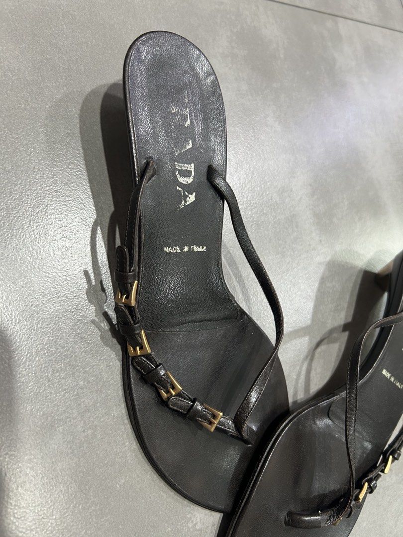 Prada Black Leather Thong Heeled Sandals Size 36 (Category: Heels) located in Santa Rosa. Submitted by missydelh (Listing ID 1448544591, Image 2). Description: - Brand: Prada - Style: Thong Sandals - Material: Black Leather - Features: Small gold buckle detail on straps - Heel Height: Moderate - Origin: Made in Italy - Size: 36 - Condition: Shows some wear on soles and insoles from use, still chic..