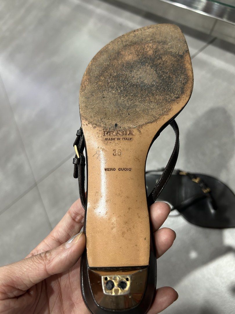 Prada Black Leather Thong Heeled Sandals Size 36 (Category: Heels) located in Santa Rosa. Submitted by missydelh (Listing ID 1448544591, Image 3). Description: - Brand: Prada - Style: Thong Sandals - Material: Black Leather - Features: Small gold buckle detail on straps - Heel Height: Moderate - Origin: Made in Italy - Size: 36 - Condition: Shows some wear on soles and insoles from use, still chic..