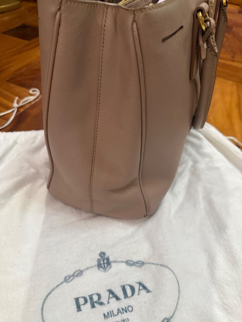 Prada Saffiano Lux Tote Bag (Category: Luxury Bags & Wallets) located in Quezon City. Submitted by bianxcloset (Listing ID 1448489222, Image 3). Description: - Authentic Prada Saffiano Lux Tote - Includes dust bag, authenticity card, and strap - Elegant gold hardware - Measurements: 13.5" L x 6" W x 9" H - Handles: Double rolled leather handles and a removable, adjustable shoulder strap - Handle Drop: 5.5" and 17-19" adjustable - Closure/Opening: