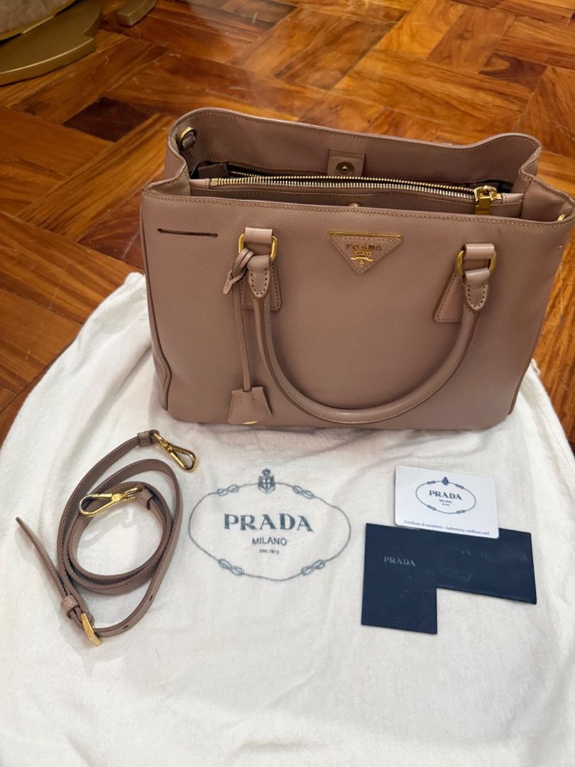 Prada Saffiano Lux Tote Bag (Category: Luxury Bags & Wallets) located in Quezon City. Submitted by bianxcloset (Listing ID 1448489222, Image 1). Description: - Authentic Prada Saffiano Lux Tote - Includes dust bag, authenticity card, and strap - Elegant gold hardware - Measurements: 13.5" L x 6" W x 9" H - Handles: Double rolled leather handles and a removable, adjustable shoulder strap - Handle Drop: 5.5" and 17-19" adjustable - Closure/Opening: