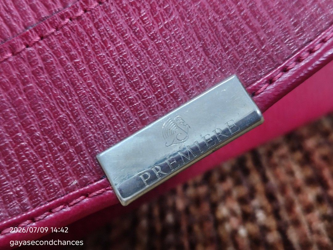 PREMIERE TED LAPIDUS PARIS CLUTCH (Category: Luxury Bags & Wallets) located in Kalibo. Submitted by secondchances.thriftsh8p (Listing ID 1448556118, Image 3). Description: - PREMIERE clutch wallet in a beautiful red. - Textured leather finish for a sophisticated look. - Secure and easy-to-use metal clasp closure. - Ample space inside to carry all your essentials. - Versatile: Ideal for evening events or daily use. - Condition: Clean and well-main