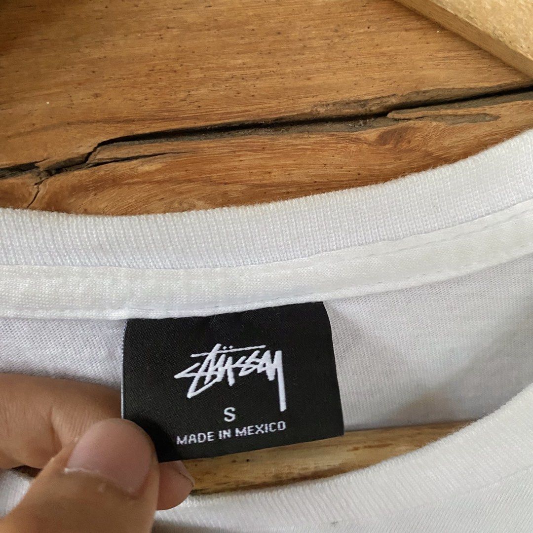 Stussy World Tour Tape (Category: Tshirts & Polo Shirts ) located in Los Banos. Submitted by rick_06 (Listing ID 1448683151, Image 3). Description: - Authentic Stussy World Tour T-Shirt - Color: White - Design: Features iconic city names (New York, Los Angeles, Tokyo, London, Paris) and Stussy logo on front and back - Material: 100% Cotton - Origin: Made in Mexico - Size: Tagged Small (S).