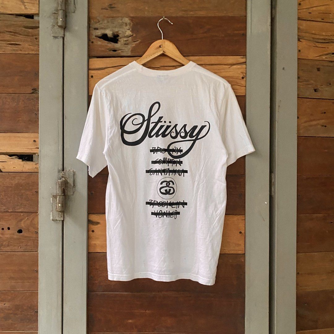 Stussy World Tour Tape (Category: Tshirts & Polo Shirts ) located in Los Banos. Submitted by rick_06 (Listing ID 1448683151, Image 2). Description: - Authentic Stussy World Tour T-Shirt - Color: White - Design: Features iconic city names (New York, Los Angeles, Tokyo, London, Paris) and Stussy logo on front and back - Material: 100% Cotton - Origin: Made in Mexico - Size: Tagged Small (S).
