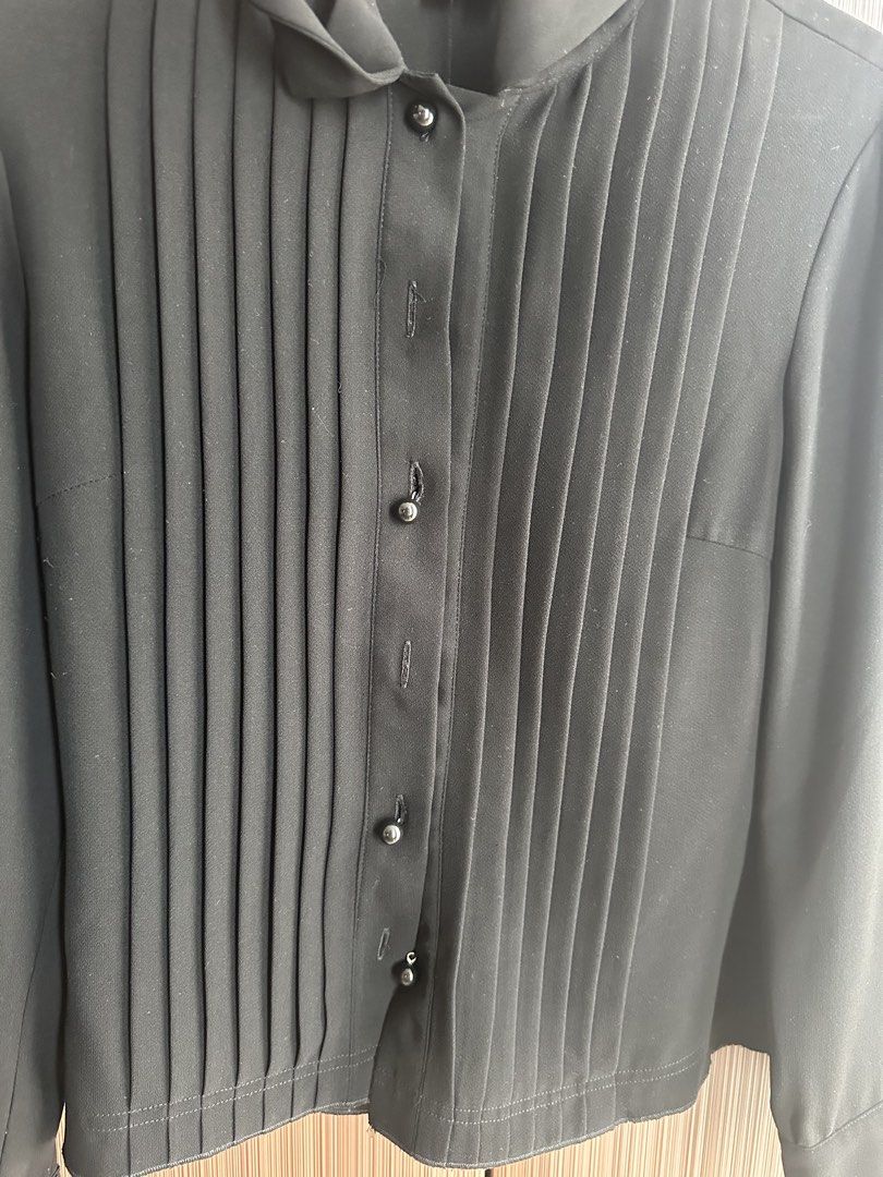 The Black Label Pleated Blouse with Tie Neck (Category: Blouses) located in Taguig. Submitted by stigmapanda (Listing ID 1448693385, Image 2). Description: - Measurements are in cm - Black long-sleeved blouse - Brand: The Black Label - Features: Pleated front, tie neck detail - Closure: Button-down front - Cuffs: Decorative buttons - Estimated Size: S - Style: Dress up or down, versatile .