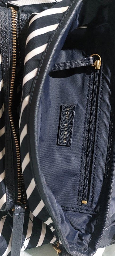 Tory Burch Striped Nylon Crossbody Bag (Category: Luxury Bags & Wallets) located in Cainta. Submitted by veronica2277 (Listing ID 1448531947, Image 2). Description: Almost new original navy white striped Tory Burch shoulder/body bag. Very nice and light. - Durable nylon material with leather trim - Main compartment with interior zip pocket - Front flap closure with secure snap button - Adjustable strap for comfortable wear - Elegant gold hardware