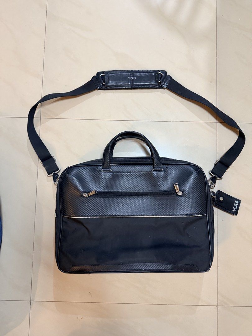 Tumi Black Leather and Nylon Briefcase with Shoulder Strap (Category: Briefcases) located in Pasay City. Submitted by marge.chang (Listing ID 1448672018, Image 2). Description: - Brand: Tumi - Color: Black - Material: Leather and Nylon - Features: Main compartment, front zip pocket - Includes: Detachable shoulder strap, leather tag, paper bag - Ideal for: Work and travel.