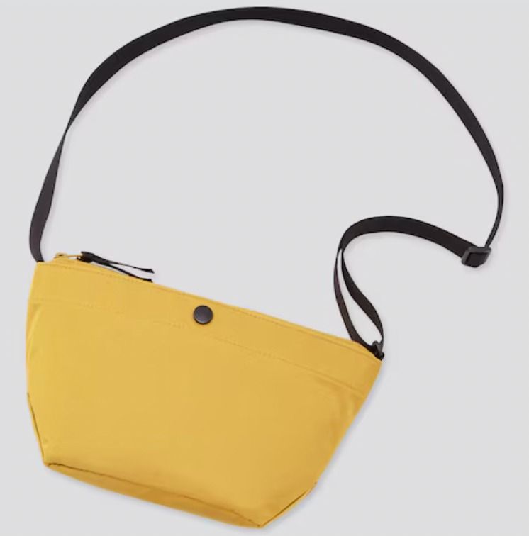 Uniqlo Nylon Mini Dumpling Sling Shoulder Bag - Yellow (Category: Cross-body Bags) located in Quezon City. Submitted by horangidee (Listing ID 1448663193, Image 1). Description: Well loved bag but still in great condition! Originally a nice yellow shade, my lighting's just horrible (feel free to ask for photos!) 💛 Nylon material, water resistant and easy to clean 💛 Adjustable straps, can make it crossbody or shoulder bag 💛 Compartments with bu