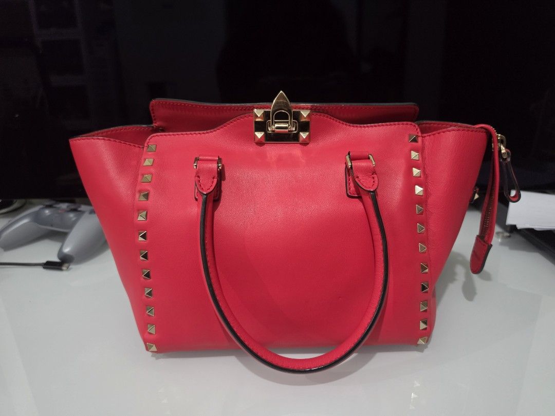 Valentino Rockstud Tote Bag in Rosso (Category: Luxury Bags & Wallets) located in Paranaque City. Submitted by joeygooey (Listing ID 1448676768, Image 1). Description: For Sale: Valentino Rockstud Tote Bag in Rosso Ranking: 8.5/10 The bag is guaranteed authentic. It has minor cosmetic flaws like normal wear and tear on the leather and handles, as seen in the photos. It has complete rockstuds, and it also comes with its original rockstud strap. Th