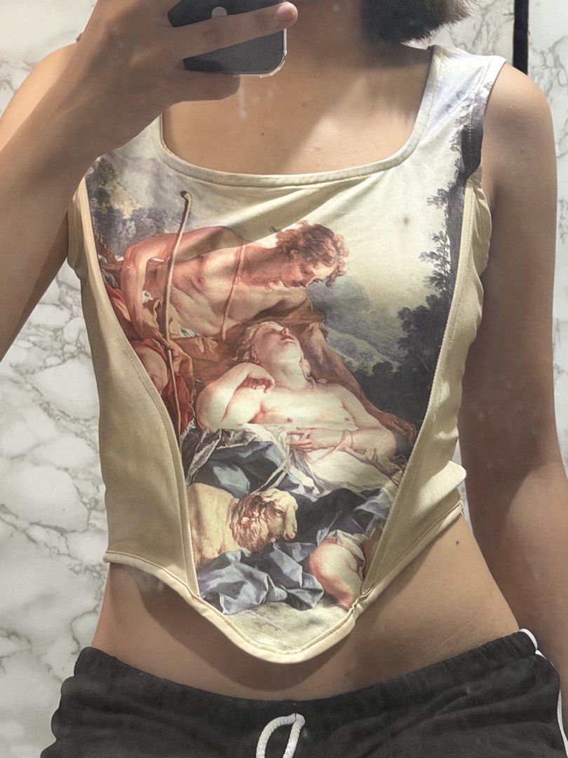 Vintage Art Print Corset Top (Category: Others Tops) located in Valenzuela. Submitted by declut.noelle (Listing ID 1448694617, Image 1). Description: - Unique corset top with a vintage art print - Features a classic art scene with figures and a sheep - Square neckline design - Flattering fit for a stylish silhouette - Ideal for creating a statement outfit - Versatile: pair with jeans or a skirt.
