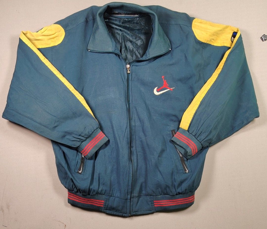 Vintage Nike Premier Track Jacket XXL (Category: Coats, Jackets and Outerwear) located in Manila. Submitted by carlitorep57860 (Listing ID 1448674997, Image 2). Description: - Vintage Nike Premier track jacket - Color: Teal blue with yellow and red accents - Features iconic Jumpman and Nike swoosh logos - Includes NBA patches on sleeves - Zipper closure - Ribbed cuffs and hem - Size: XXL.