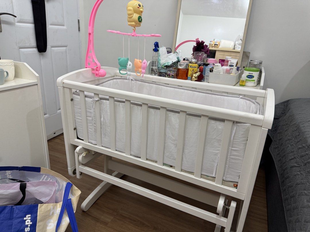 White Baby Crib with Mobile and Glider Base (Category: Cots & Cribs) located in Manila. Submitted by deddelyn (Listing ID 1448496588, Image 2). Description: Bought this on Mother Care Store Shangrila ( solid wood) almost 20k original price, selling now 6900 only, crib only, yung side bedding 3k sa sm mega mall na bili kahit 1500 na lang then yung foam free na. Head pillow and 2 long pillows 500 na lang nabili ko don ng 2k sa megamall. You’ll sa p