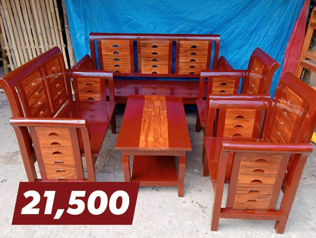 Wooden Sofa Set with Coffee Table (Category: Sofas) located in Iloilo. Submitted by semicglinda (Listing ID 1448602672, Image 1). Description: - Complete wooden sofa set - Includes: 3-seater sofa, two single chairs, and a coffee table - Rich, dark wood finish with lighter wood accents - Coffee table features a convenient lower shelf for storage - Ideal for enhancing your living room - Price: PHP 21,500.