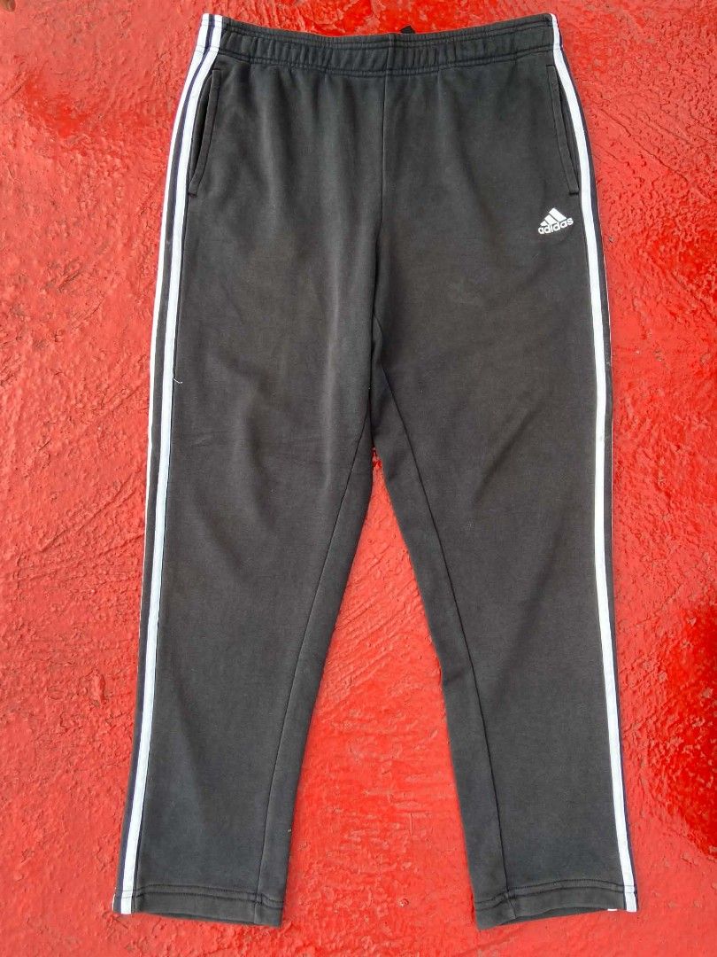 Adidas Jogger Pants with White Stripes (Category: Other Bottoms) located in Manila. Submitted by lemlem_10 (Listing ID 1453140431, Image 1). Description: - Classic dark grey Adidas joggers - Iconic white stripes down the sides - Comfortable elastic waistband with drawstring - Two side pockets - Versatile for casual wear or workouts.