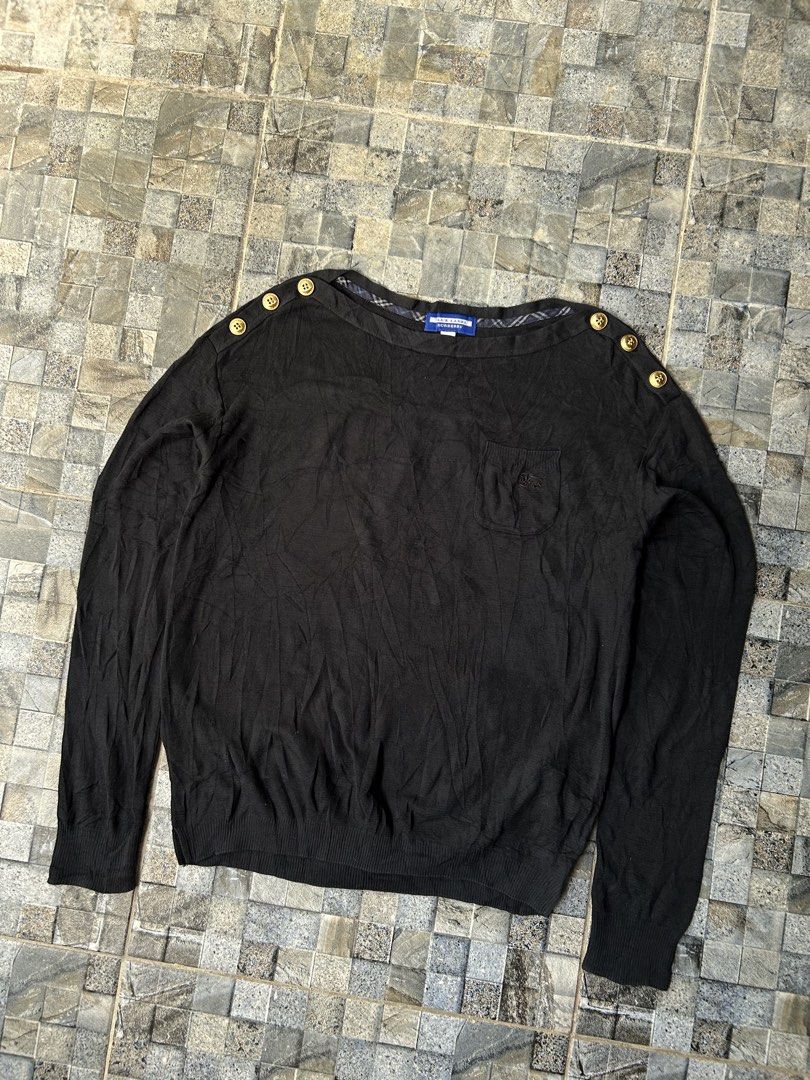 Burberry Blue Label Black Knitted Sweater (Category: Coats, Jackets and Outerwear) located in Quezon City. Submitted by commonwealthpickerph (Listing ID 1453130471, Image 2). Description: Authentic Burberry Blue Label black long-sleeved sweater - 18 width // 22 length - Elegant gold button details on the shoulder - Convenient small chest pocket - Subtle Burberry plaid lining inside the neckline - Soft and comfortable knit fabric - Perfect for ver