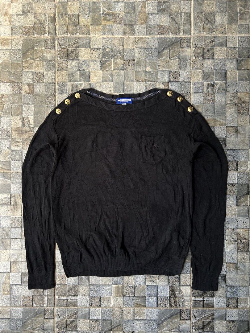 Burberry Blue Label Black Knitted Sweater (Category: Coats, Jackets and Outerwear) located in Quezon City. Submitted by commonwealthpickerph (Listing ID 1453130471, Image 1). Description: Authentic Burberry Blue Label black long-sleeved sweater - 18 width // 22 length - Elegant gold button details on the shoulder - Convenient small chest pocket - Subtle Burberry plaid lining inside the neckline - Soft and comfortable knit fabric - Perfect for ver