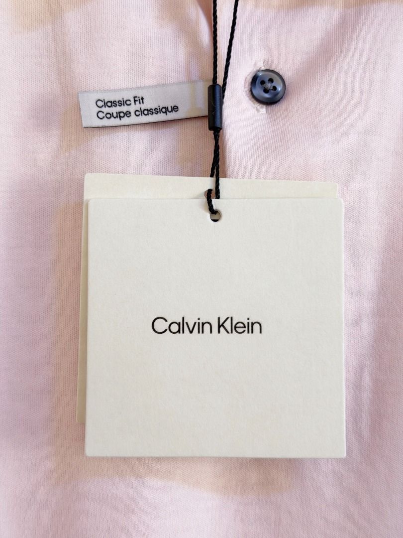 Calvin Klein light pink polo shirt (Category: Tshirts & Polo Shirts ) located in Quezon City. Submitted by homestyleplus (Listing ID 1453213931, Image 3). Description: Calvin Klein light pink polo shirt - Bought in Canada - size on tag: US men's XL - chest: up to 50" (approximate) - length: 30.5” (approximate) - with hang tag *color of item on photos may vary from its actual color due to editing/lighting ----- MOP: BPI / Gcash First to pay basis 