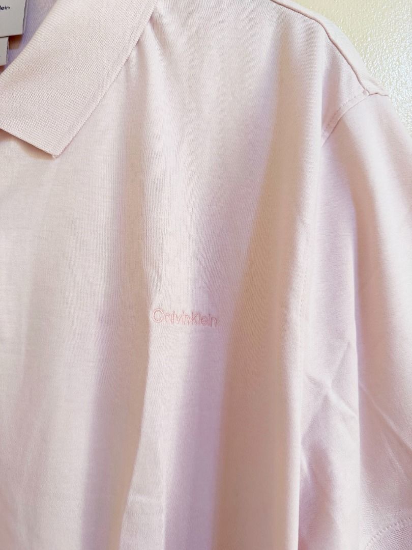 Calvin Klein light pink polo shirt (Category: Tshirts & Polo Shirts ) located in Quezon City. Submitted by homestyleplus (Listing ID 1453213931, Image 2). Description: Calvin Klein light pink polo shirt - Bought in Canada - size on tag: US men's XL - chest: up to 50" (approximate) - length: 30.5” (approximate) - with hang tag *color of item on photos may vary from its actual color due to editing/lighting ----- MOP: BPI / Gcash First to pay basis 