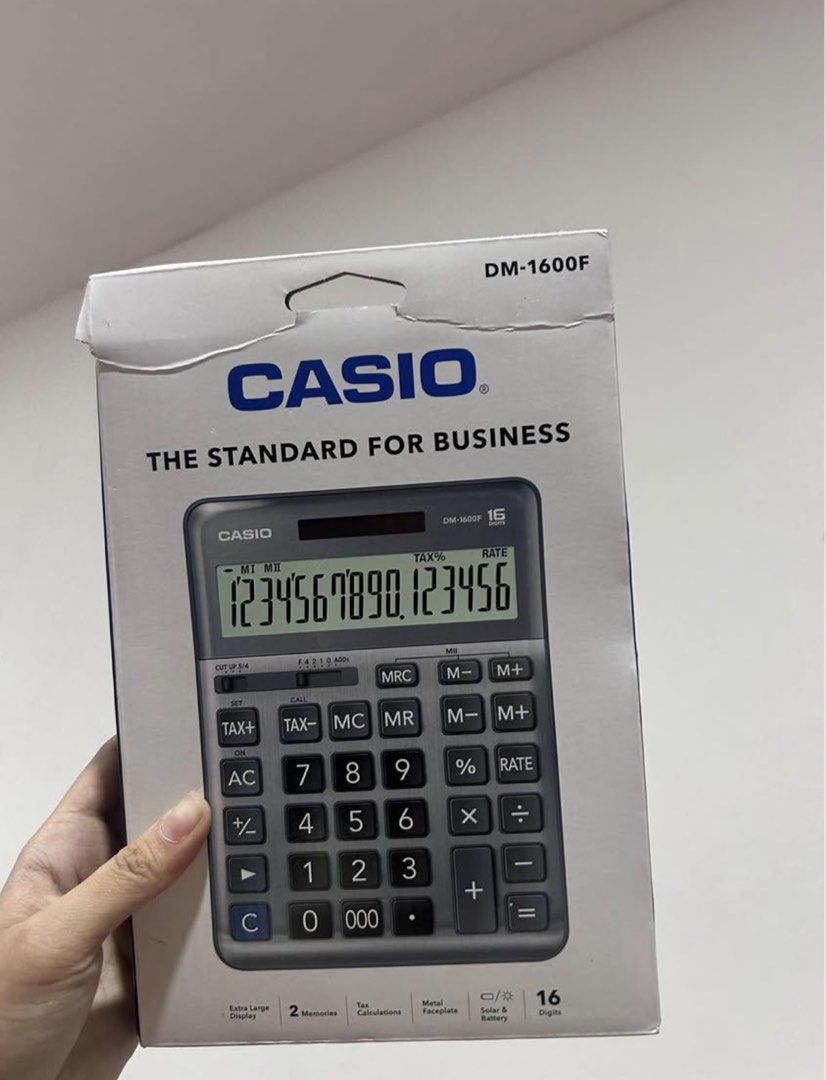 Casio DM-1600F Calculator - Standard for Business (Category: Office & Business Technology) located in Imus. Submitted by aaa1111__ (Listing ID 1453076852, Image 1). Description: - Casio DM-1600F Calculator - Ideal for Business Use - Extra Large 16-Digit Display - 2 Memory Functions - Tax Calculation Feature - Durable Metal Faceplate - Solar & Battery Powered - Suitable for Office or Personal Use.