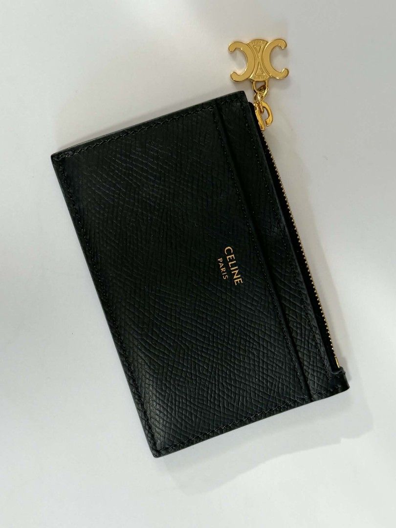 Celine Zipped Card Holder (Category: Luxury Bags & Wallets) located in Paranaque City. Submitted by jhenrobielos (Listing ID 1453166204, Image 1). Description: Celine Zipped Card Holder in Black Grained Calfskin features a gold-tone Triomphe charm on the zipper pull. Brand: Celine Model: Zipped Card Holder Triomphe Charms Material: Grained Calfskin Color: Black Authentic Like new.