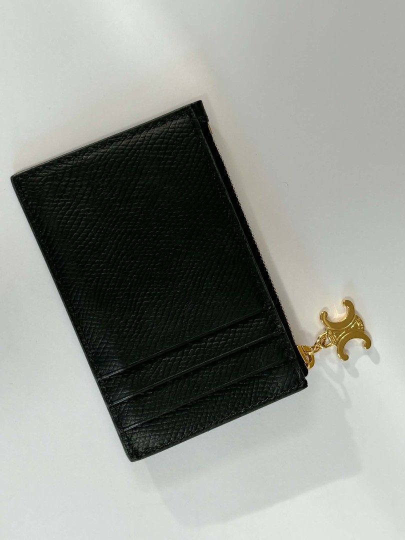 Celine Zipped Card Holder (Category: Luxury Bags & Wallets) located in Paranaque City. Submitted by jhenrobielos (Listing ID 1453166204, Image 2). Description: Celine Zipped Card Holder in Black Grained Calfskin features a gold-tone Triomphe charm on the zipper pull. Brand: Celine Model: Zipped Card Holder Triomphe Charms Material: Grained Calfskin Color: Black Authentic Like new.
