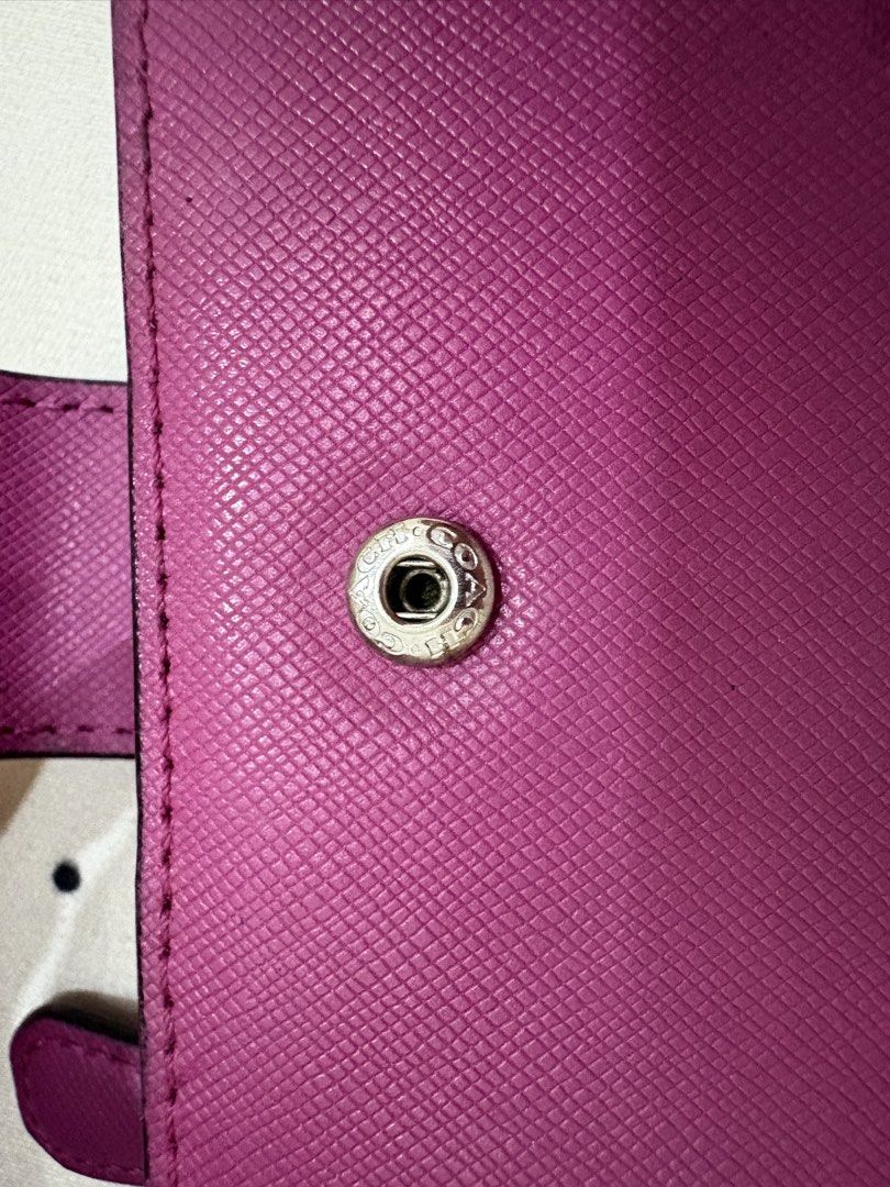 Coach Pink Saffiano Leather Bifold Wallet (Category: Luxury Bags & Wallets) located in Manila. Submitted by alyannaros79007 (Listing ID 1453096482, Image 3). Description: - Coach bifold wallet in a beautiful pink shade. - Crafted from durable Saffiano leather. - Ample card slots for your essentials. - Secure snap closure. - Convenient zip coin pocket. - Shows minor wear on corners and edges, but has plenty of life left..