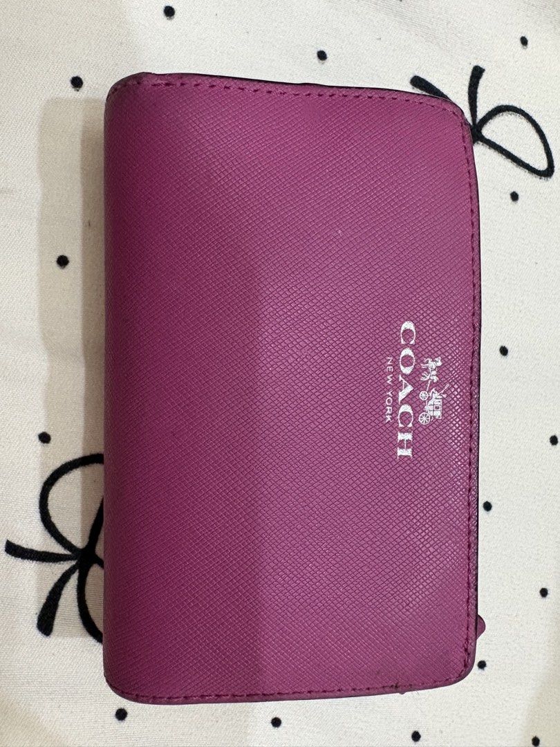 Coach Pink Saffiano Leather Bifold Wallet (Category: Luxury Bags & Wallets) located in Manila. Submitted by alyannaros79007 (Listing ID 1453096482, Image 1). Description: - Coach bifold wallet in a beautiful pink shade. - Crafted from durable Saffiano leather. - Ample card slots for your essentials. - Secure snap closure. - Convenient zip coin pocket. - Shows minor wear on corners and edges, but has plenty of life left..