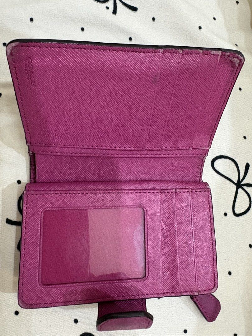 Coach Pink Saffiano Leather Bifold Wallet (Category: Luxury Bags & Wallets) located in Manila. Submitted by alyannaros79007 (Listing ID 1453096482, Image 2). Description: - Coach bifold wallet in a beautiful pink shade. - Crafted from durable Saffiano leather. - Ample card slots for your essentials. - Secure snap closure. - Convenient zip coin pocket. - Shows minor wear on corners and edges, but has plenty of life left..
