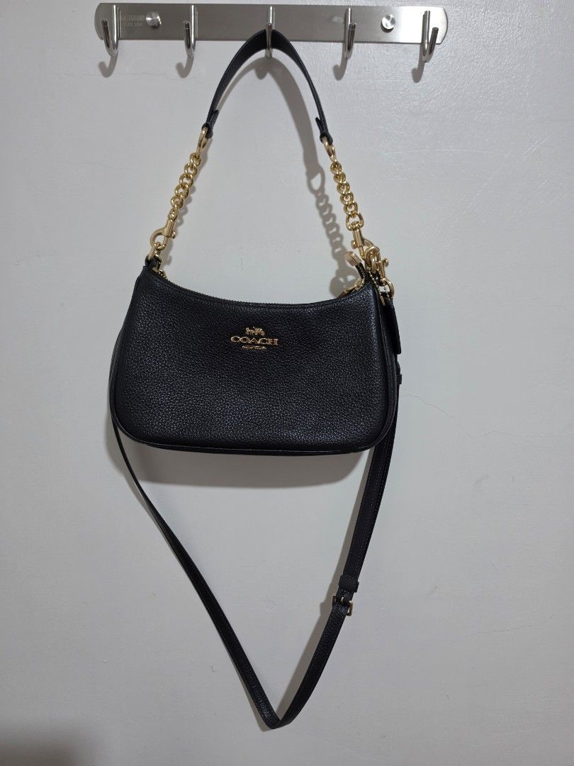 Coach Teri Black Pebbled Leather Chain Shoulder Bag (Category: Luxury Bags & Wallets) located in Lucena. Submitted by gladiola_26 (Listing ID 1453229558, Image 2). Description: - Brand: Coach - Material: Black pebbled leather - Hardware: Gold-tone - Strap: Chain strap - Closure: Zipper - Interior: Fabric lining with Coach tag and serial number - Style: Versatile for everyday use or nights out Original. rfs: decluttering and need funds.