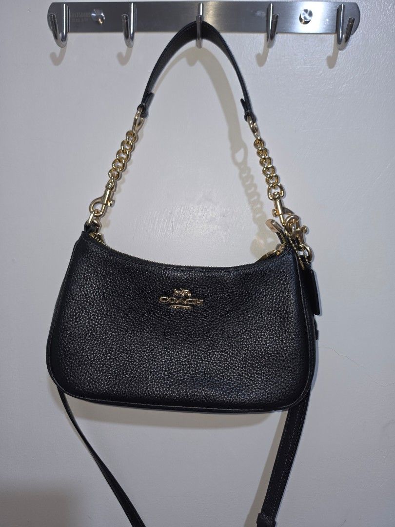 Coach Teri Black Pebbled Leather Chain Shoulder Bag (Category: Luxury Bags & Wallets) located in Lucena. Submitted by gladiola_26 (Listing ID 1453229558, Image 1). Description: - Brand: Coach - Material: Black pebbled leather - Hardware: Gold-tone - Strap: Chain strap - Closure: Zipper - Interior: Fabric lining with Coach tag and serial number - Style: Versatile for everyday use or nights out Original. rfs: decluttering and need funds.
