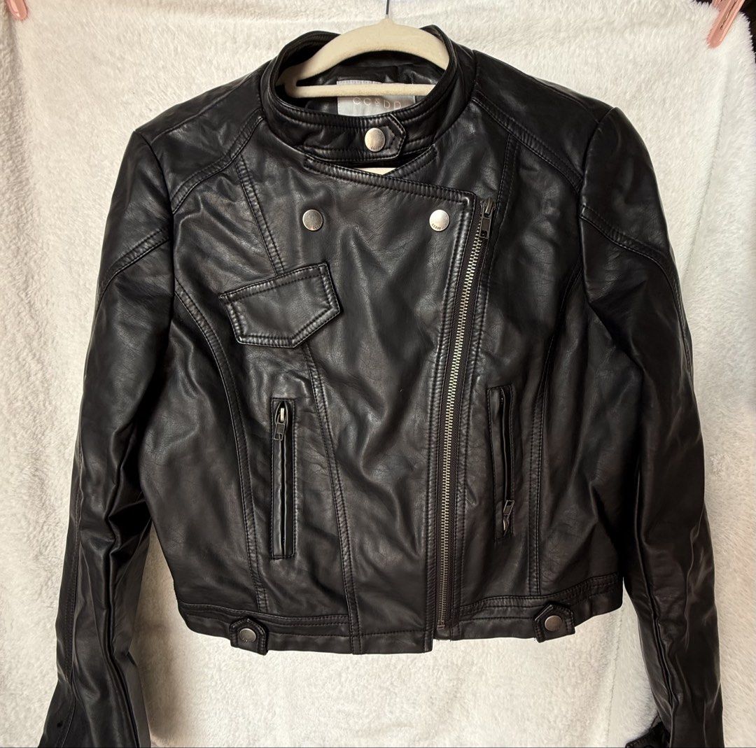 Cropped Black Leather Racer Jacket (Category: Coats, Jackets and Outerwear) located in Manila. Submitted by quesera.ph_ (Listing ID 1453095828, Image 2). Description: 📍Color may vary due to lighting - Classic black racer jacket from CC&DD -cropped - Made of faux leather - Features zip-up front and multiple zippered pockets - Snap button collar detail - Versatile for layering with jeans or dresses - NO stain, peeling or leather cracking.