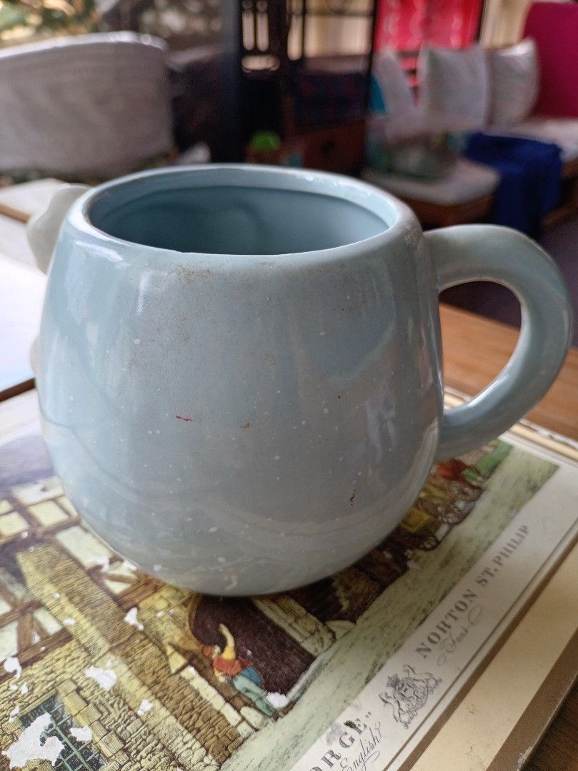 Cute Koala Hugging Mug (Category: Coffee & Tea Tableware) located in Makati City. Submitted by meowmyella (Listing ID 1453061907, Image 2). Description: - Adorable light blue mug featuring a koala hugging the side. - Perfect for your morning coffee or tea. - Microwave safe for convenient heating. - Please note: Hand wash recommended (not dishwasher safe). - A charming addition to your kitchenware collection. - with chips on the lip Kindly send DM