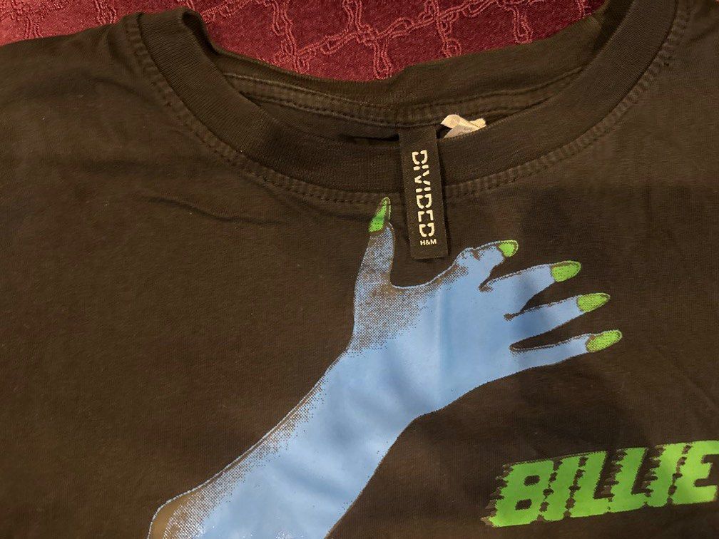 Divided Billie Eilish Graphic T-Shirt Croptop (Category: Shirts) located in Manila. Submitted by declutterthisandthat (Listing ID 1453116813, Image 2). Description: - Cool Billie Eilish graphic print on black tee - Features eye-catching blue hands and green text - Classic short sleeves and crew neck design - A must-have for any Billie Eilish fan - Versatile for pairing with jeans or shorts.
